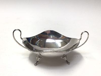 Lot 294 - Edwardian silver dish with planished decoration, (Birmingham 1906), maker George, Nathan and Ridley Hayes, together with a George V silver topped scent bottle (London 1916), a George V silver two h...