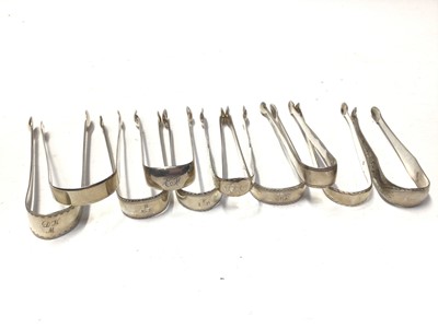 Lot 329 - Ten pairs of George III silver sugar tongs, most with bright cut engraved decoration, various dates and makers, mostly circa 1800, all at approximately 10oz, (10)