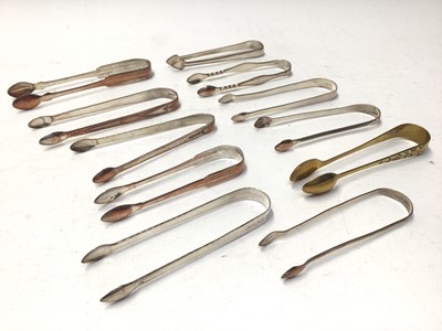 Lot 331 - Eleven pairs of George III Old Sheffield plate and other sugar tongs, some with bright cut engraved decoration, (10)