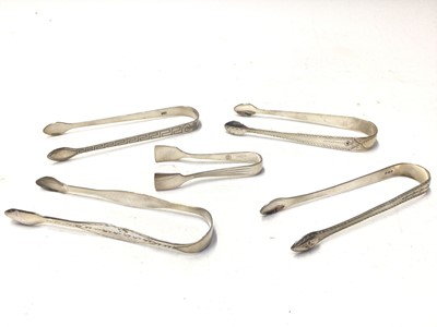 Lot 333 - Eight pairs of George III, filigree and other silver sugar tongs, various dates and makers, all at approximately 6oz, (8)