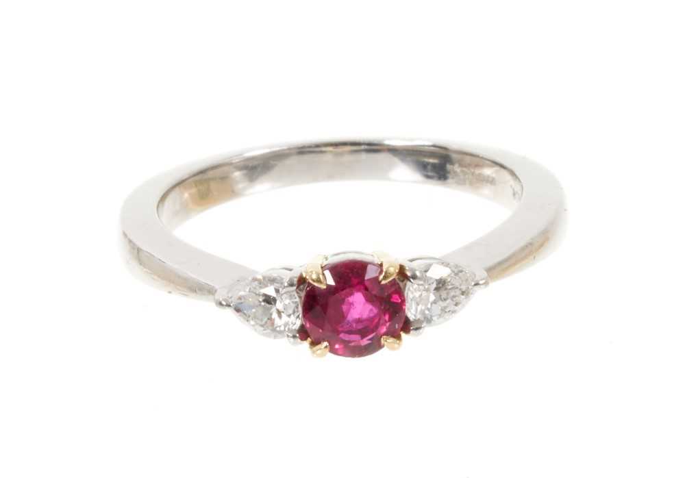 Lot 507 - Tiffany & Co. ruby and diamond three stone platinum ring, the round mixed cut ruby estimated to weigh approximately 0.40cts in 18ct yellow gold claw setting flanked by two pear cut diamonds estimat...