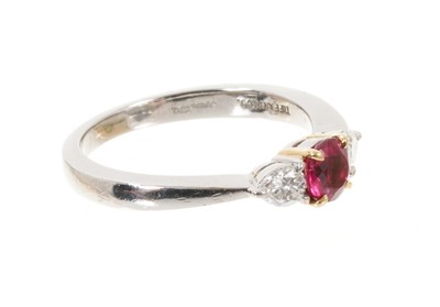 Lot 507 - Tiffany & Co. ruby and diamond three stone platinum ring, the round mixed cut ruby estimated to weigh approximately 0.40cts in 18ct yellow gold claw setting flanked by two pear cut diamonds estimat...