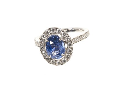 Lot 578 - Sapphire and diamond cluster ring with a cushion cut unheated Burmese blue sapphire weighing 2.02cts surrounded by a 'halo' mount of brilliant cut diamonds with further diamonds to the shoulder...