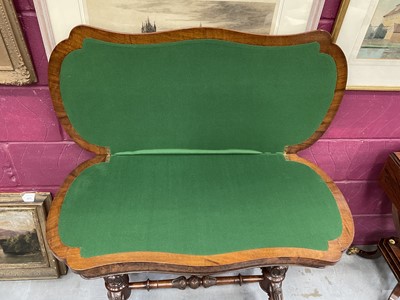 Lot 1213 - Victorian burr walnut veneered card table with shaped fold-over top on carved and turned supports with turned stretcher on cabriole legs terminating on original ceramic casters