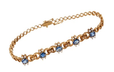 Lot 532 - Sapphire and diamond bracelet with five oval mixed cut blue sapphires and brilliant cut diamonds in 14ct yellow gold setting, 18cm.