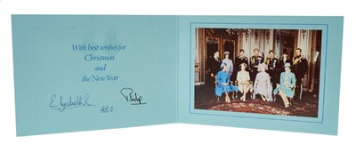 Lot 45 - H.M.Queen Elizabeth II and H.R.H.The Duke of Edinburgh, signed 1980 Christmas card with twin gilt Royal ciphers to cover and colour photograph of the Royal Family with dogs to interior