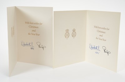 Lot 48 - H.M.Queen Elizabeth II and H.R.H.The Duke of Edinburgh, two signed 1984 and 1985 Christmas cards with twin gilt Royal ciphers to interiors and colour photograph of the Royal Couple to fronts (2)