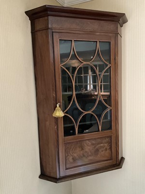 Lot 1276 - George III mahogany and boxwood line inlaid corner cupboard, enclosed by an astragal glazed door, 68cm wide x 41cm deep x 108cm high