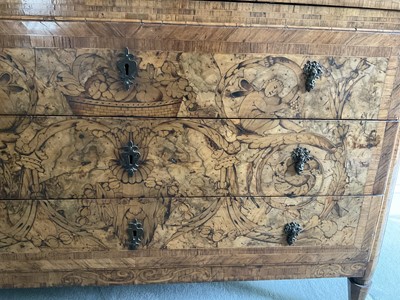 Lot 1257 - Impressive early 18th century Italian figured walnut crossbanded and marquetry inlaid commode, the top with shaped angles, over four drawers, each with early paper lining, on tapered feet, a note i...
