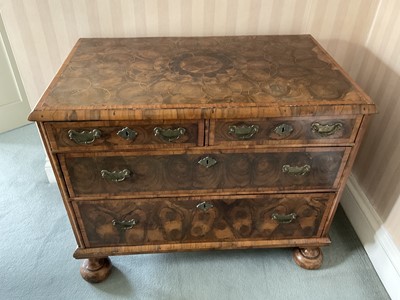 Lot 1259 - Rare William and Mary laburnum oyster veneered chest of drawers, with concentric veneered top and two short over two long drawers raised on later bun feet, probably formerly a chest on stand. 91cm...