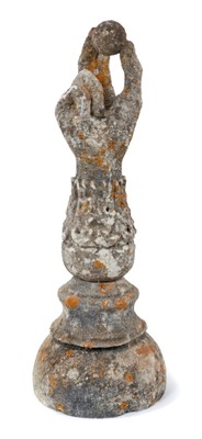 Lot 823 - Antique composition garden finial, in the form of a forearm, holding a ball, 41cm high