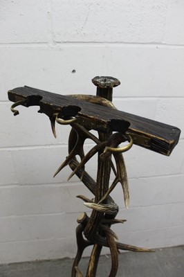 Lot 1310 - Antique Tyrolean hunting lodge worked antler gun stand, with three housings, on spread base, 134cm high