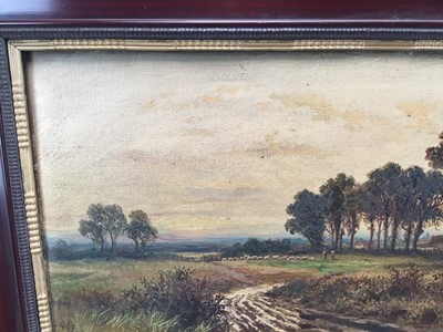 Lot 191 - 19th century oil painting by J Lewis, fields with trees and church in background and sheep and shepherd in distance. 30cm x 60cm, framed