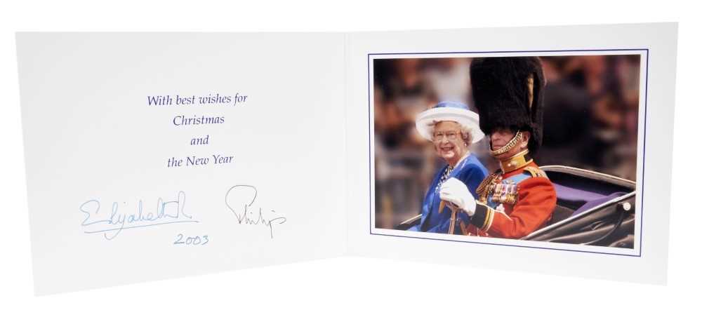 Lot 84 - H.M.Queen Elizabeth II and H.R.H. The Duke of Edinburgh, signed 2003 Christmas card with twin gilt Royal ciphers to cover and colour photograph of the Queen and Prince Philip in a carriage to the i...