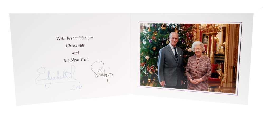 Lot 91 - H.M.Queen Elizabeth II and H.R.H. The Duke of Edinburgh, signed 2010 Christmas card with twin gilt Royal ciphers to cover and colour photograph of the Royal Couple by a Christmas tree to the interi...