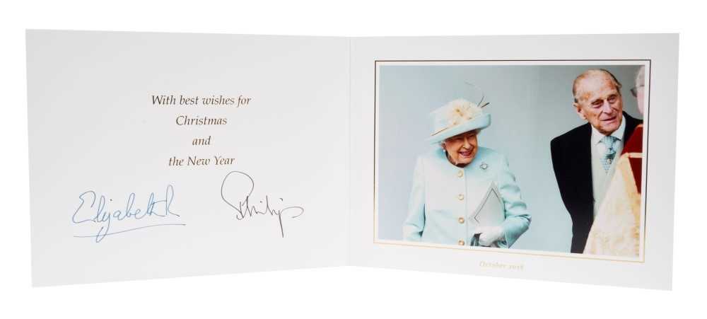 Lot 98 - H.M.Queen Elizabeth II and H.R.H. The Duke of Edinburgh, signed 2018 Christmas card with twin gilt Royal ciphers to cover and colour photograph of the Royal couple leaving church to the interior- w...