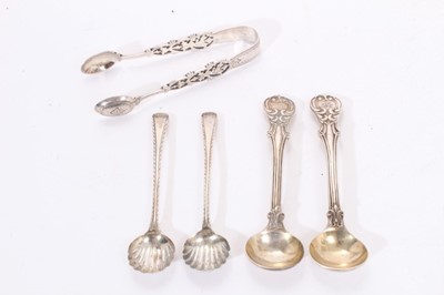 Lot 448 - Two pairs of silver salt spoons and a pair of pierced and engraved silver sugar tongs