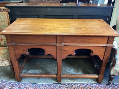 Lot 1431 - Victorian Gothic pitch pine table with carved gothic foliage on square chamfered legs joined by stretchers, 152cm long, 71cm wide and 92cm high.