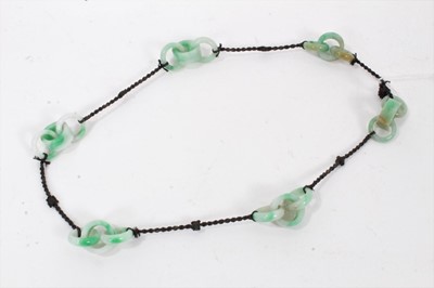 Lot 857 - Collection of eighteen Chinese jade interlocking rings joined by thread