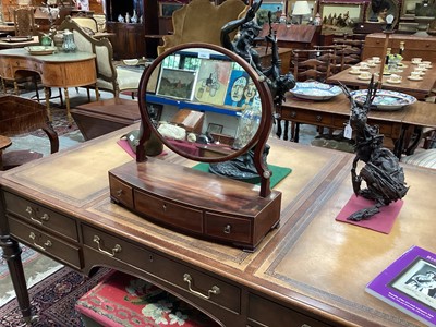 Lot 1426 - George III mahogany toilet mirror with oval mirrored plate and three drawers below, 58cm.