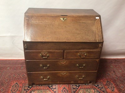 Lot 1307 - George III oak bureau with fitted interior with secret compartments and writing well, two short and two long drawers below on bracket feet, 96cm wide x 61cm deep x 95cm high