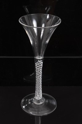 Lot 271 - Georgian toasting glass of tall slender form with trumpet bowl, opaque twist stem on splayed foot 18cm
