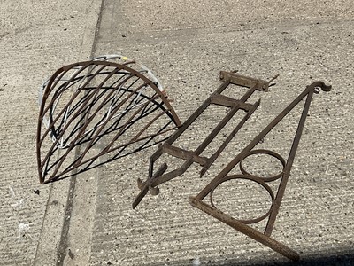 Lot 1329 - Two 19th century iron swing sign brackets and two iron hayracks corner mounted 19th century