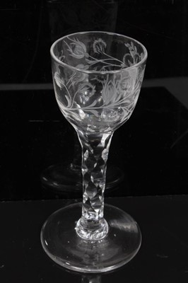 Lot 277 - Two Georgian wine glasses with floral and swag cut bowls on faceted stems on splayed foot 13.5-14 cm (2)