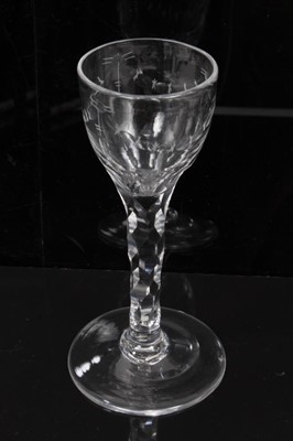 Lot 277 - Two Georgian wine glasses with floral and swag cut bowls on faceted stems on splayed foot 13.5-14 cm (2)