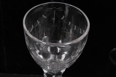 Lot 277 - Two Georgian wine glasses with floral and swag cut bowls on faceted stems on splayed foot 13.5-14 cm (2)