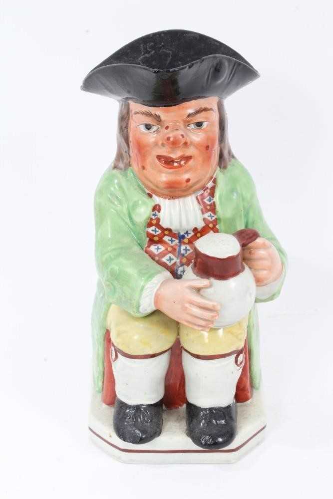 Lot 291 - Early 19th century Staffordshire Pearlware Toby jug, in green jacket and brightly coloured waistcoat, with spotty red face, 24cm high