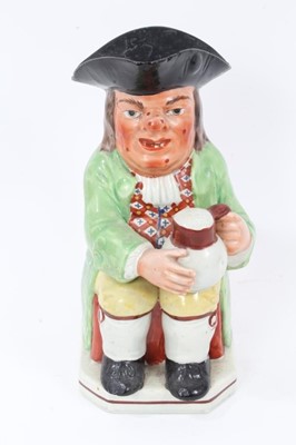 Lot 291 - Early 19th century Staffordshire Pearlware Toby jug, in green jacket and brightly coloured waistcoat, with spotty red face, 24cm high