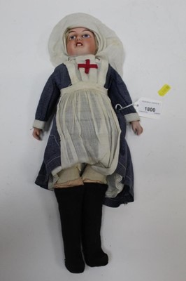 Lot 1800 - Early 20th century Continental bisque head and shoulder porcelain doll dressed as a First World War nurse.