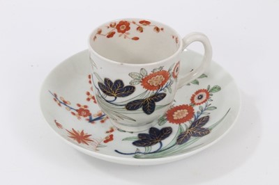 Lot 5 - A Worcester 'Kempthorne' coffee cup and saucer, circa 1770, polychrome painted with stylised flower sprays, pseudo-Chinese mark to bases, the saucer measuring 13cm diameter