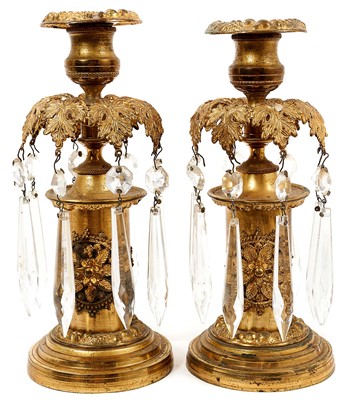 Lot 709 - Pair of Regency gilt metal lustres / candlesticks with prismatic glass drops