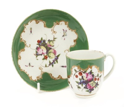 Lot 19 - A Worcester cup and saucer, circa 1770, decorated in the atelier of James Giles with floral sprays and insects on a green ground, crossed swords mark to saucer, the saucer measuring 13cm diameter