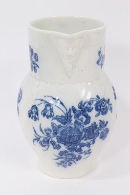 Lot 25 - A Caughley blue and white cabbage leaf moulded jug with mask spout, decorated with bouquets of flowers, S mark to base, 14.5cm high