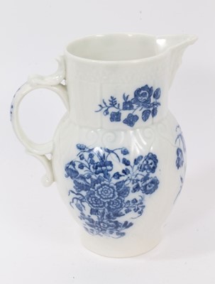 Lot 25 - A Caughley blue and white cabbage leaf moulded jug with mask spout, decorated with bouquets of flowers, S mark to base, 14.5cm high