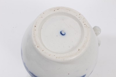 Lot 28 - Worcester blue and white jug, circa 1780, printed in blue with the Parrot Pecking Fruit pattern, mask spout, crescent mark to base, 15cm high