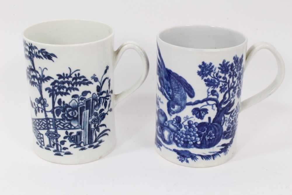 Lot 37 - Two Worcester blue and white tankards, circa 1780, one printed with the Parrot Pecking Fruit pattern, the other with the Fence pattern, both with crescent marks, 11.75cm and 12cm high