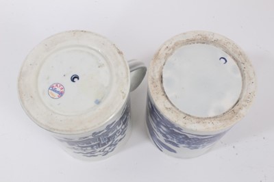 Lot 37 - Two Worcester blue and white tankards, circa 1780, one printed with the Parrot Pecking Fruit pattern, the other with the Fence pattern, both with crescent marks, 11.75cm and 12cm high