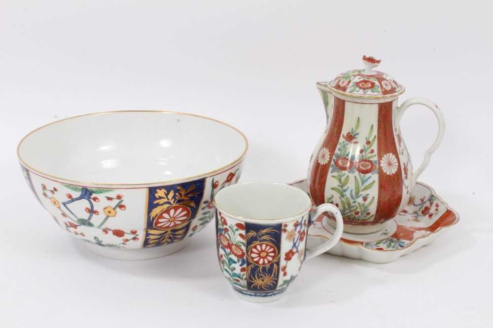 Lot 40 - Worcester Kakiemon style porcelain, circa 1770, including a sparrow beak jug, cover and dish on an orange ground, and a bowl and coffee cup on a blue ground (5)