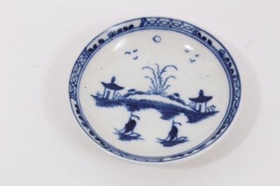 Lot 41 - A Caughley miniature blue and white tea bowl and saucer, circa 1780, decorated in the Island pattern, together with a miniature blue and white cup painted with flowers, probably Worcester (3)