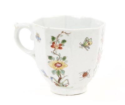 Lot 51 - A Worcester coffee cup, circa 1753, of octagonal form with a scrollwork handle, the sides painted with flowering plants alternating with insects in flight, 5.25cm high