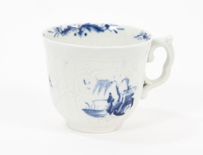Lot 60 - A Worcester blue and white coffee cup, circa 1758, of moulded strap-fluted form with scroll handle, painted with the Fisherman and Willow Pavilion pattern, workman's mark, 5.25cm high