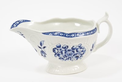 Lot 64 - A Worcester blue and white sauceboat, circa 1775, painted with flowers, crescent mark, 17.5cm long