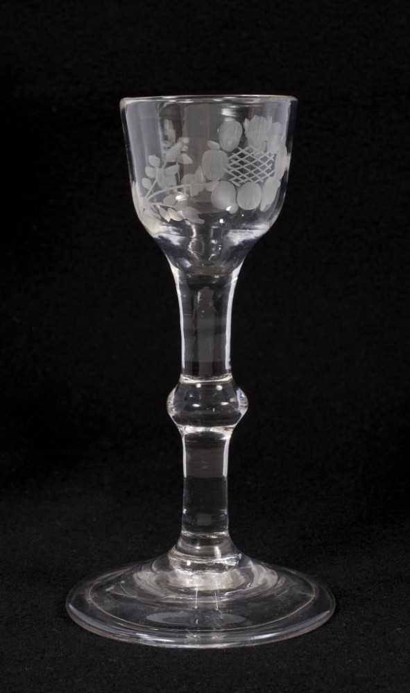Lot 70 - Georgian baluster stem wine glass, circa 1740, the ogee bowl with etched foliate decoration, with folded conical foot, 13.5cm high