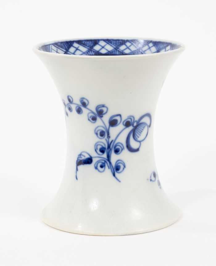 Lot 75 - A Liverpool Pennington blue and white waisted vase, circa 1790, painted with flowers, 9cm high