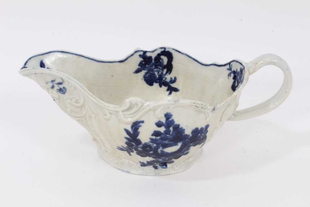 Lot 77 - A Liverpool Pennington blue and white sauceboat, circa 1790, printed with floral sprays, exhibited at Philllips in 1997, 20cm from spout to handle