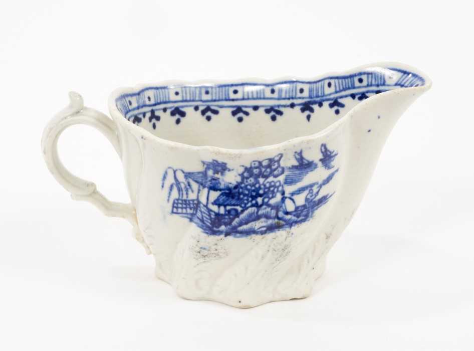 Lot 79 - A Liverpool Pennington blue and white creamboat, circa 1790, of Low Chelsea Ewer form, printed with the Fence pattern, 12cm from spout to handle